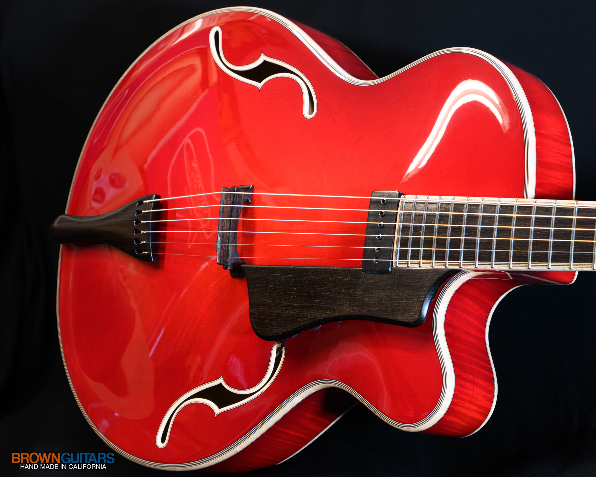 Hand-carved arm contour bevel on solid wood archtop